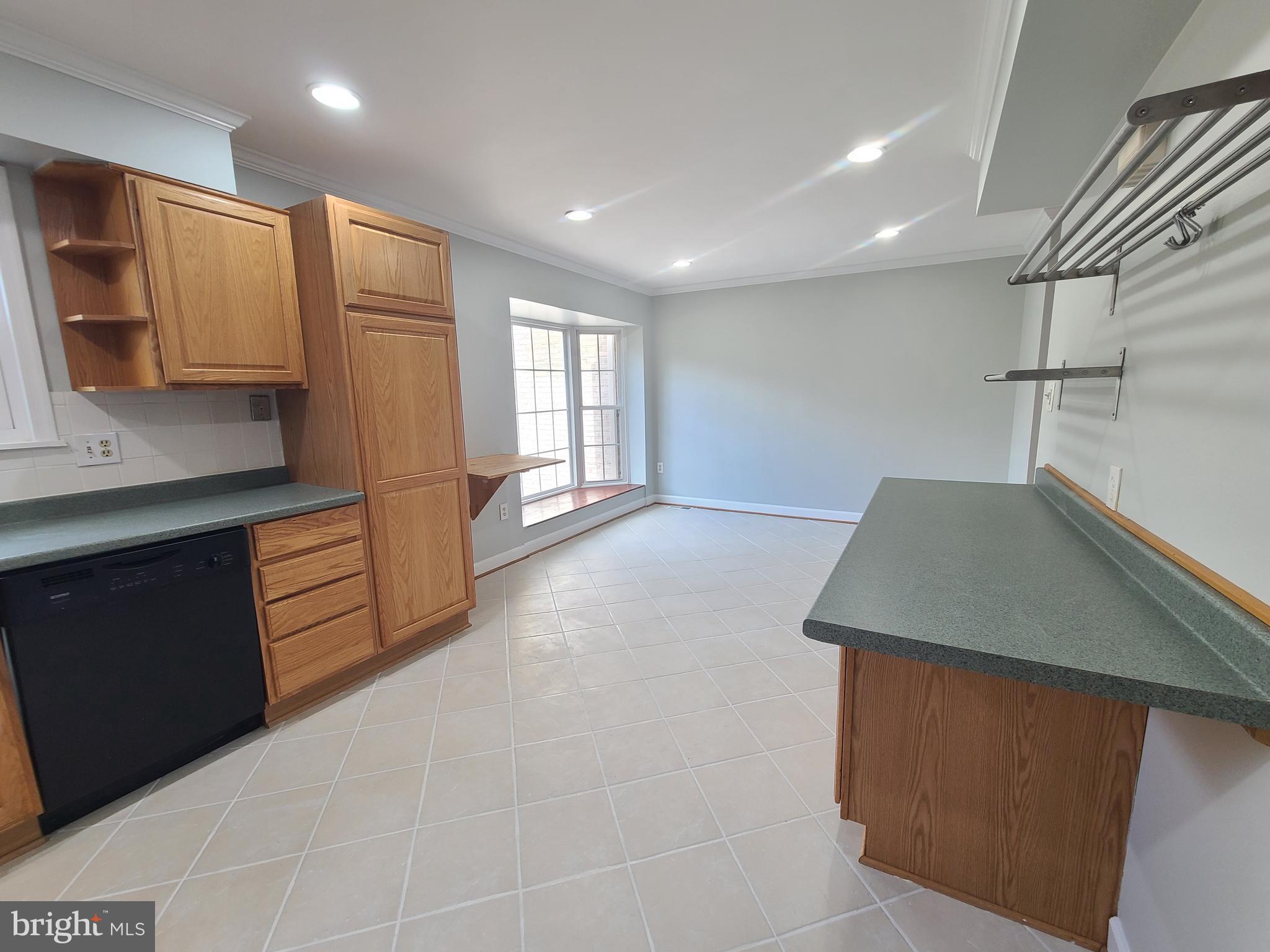 6644 Green Ash Drive Springfield, VA 22152 - Photo 15 of 42 a kitchen with stainless steel appliances granite countertop a sink a stove and a refrigerator