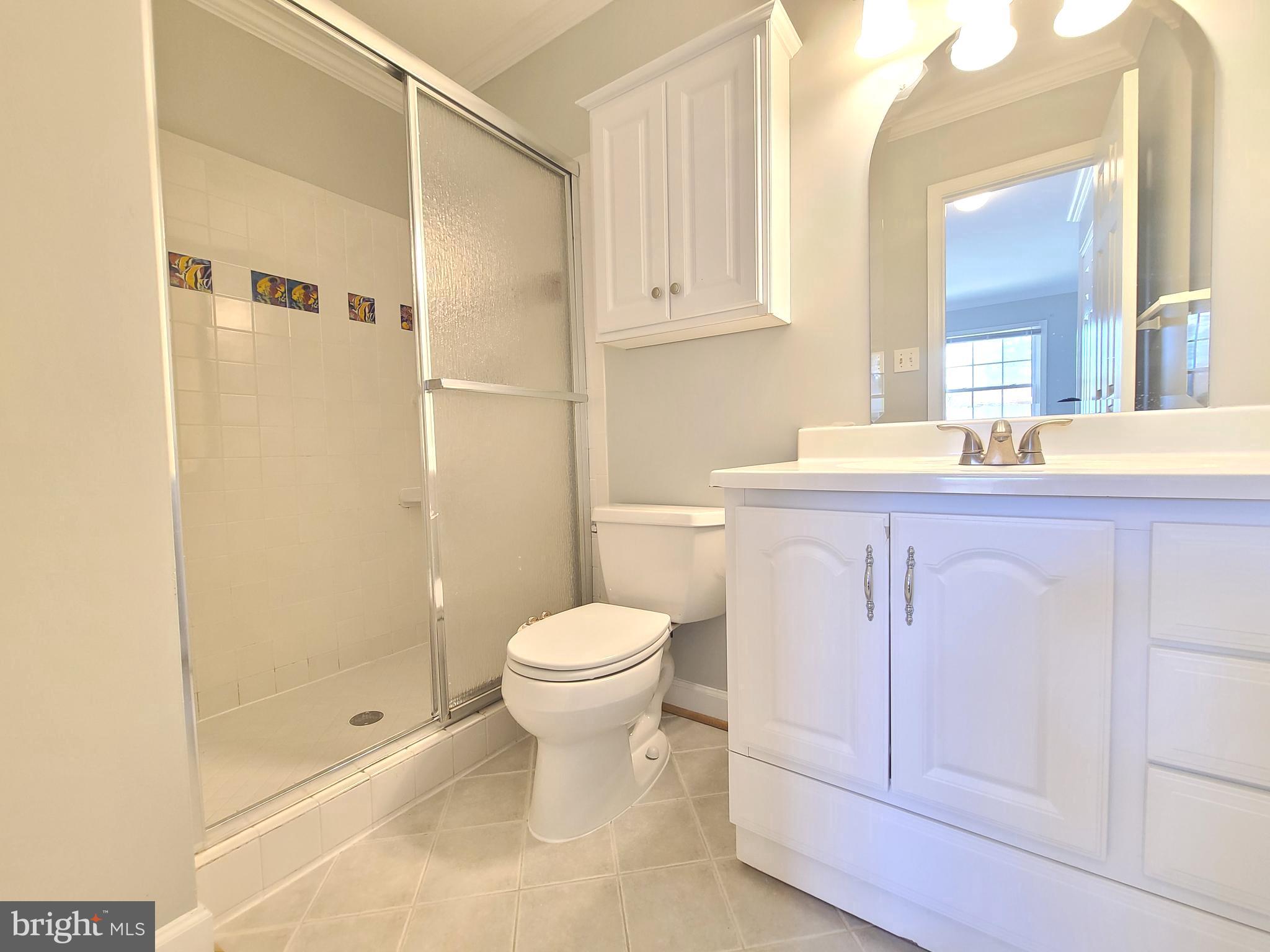 6644 Green Ash Drive Springfield, VA 22152 - Photo 23 of 42 a bathroom with a sink a toilet and shower