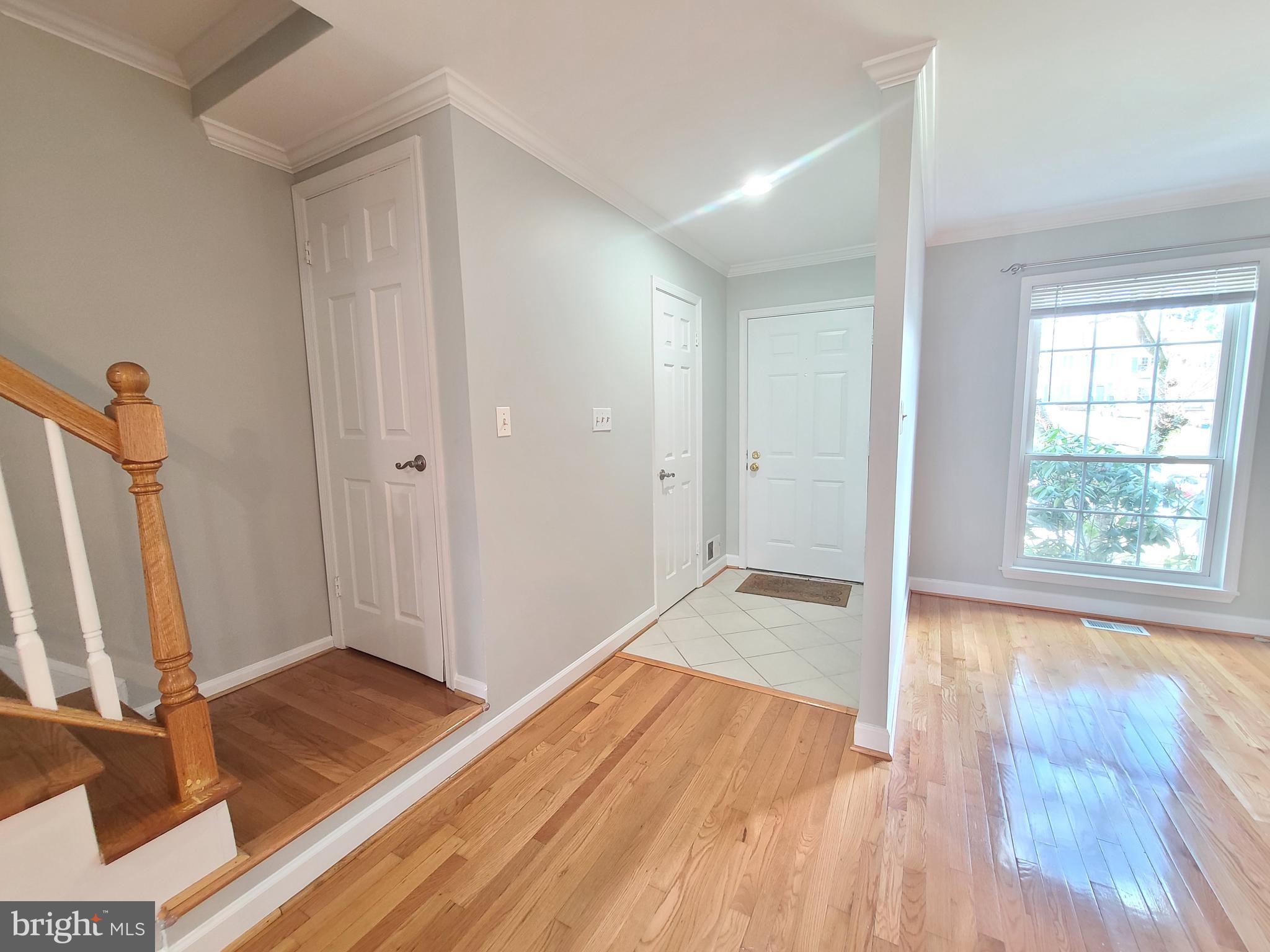 6644 Green Ash Drive Springfield, VA 22152 - Photo 3 of 42 a view of an empty room with wooden floor and a window