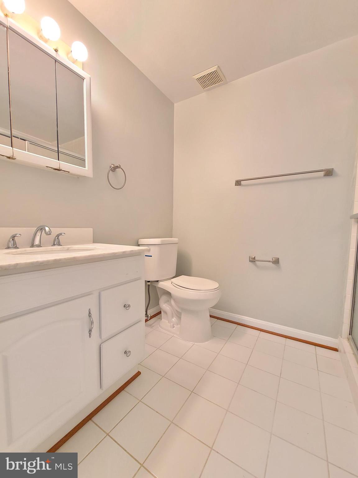 6644 Green Ash Drive Springfield, VA 22152 - Photo 37 of 42 a bathroom with a sink toilet and mirror