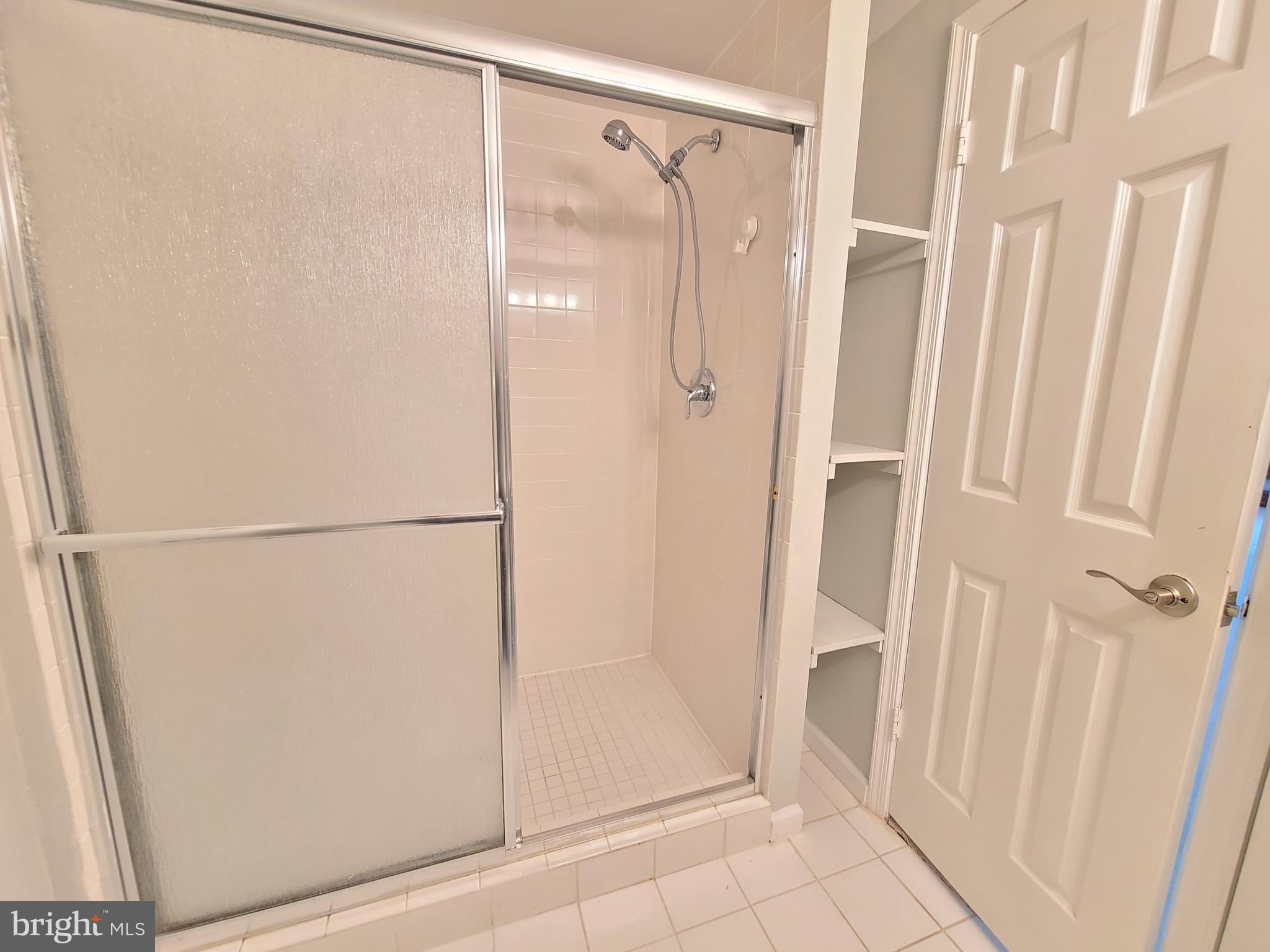 6644 Green Ash Drive Springfield, VA 22152 - Photo 38 of 42 a bathroom with a glass shower door