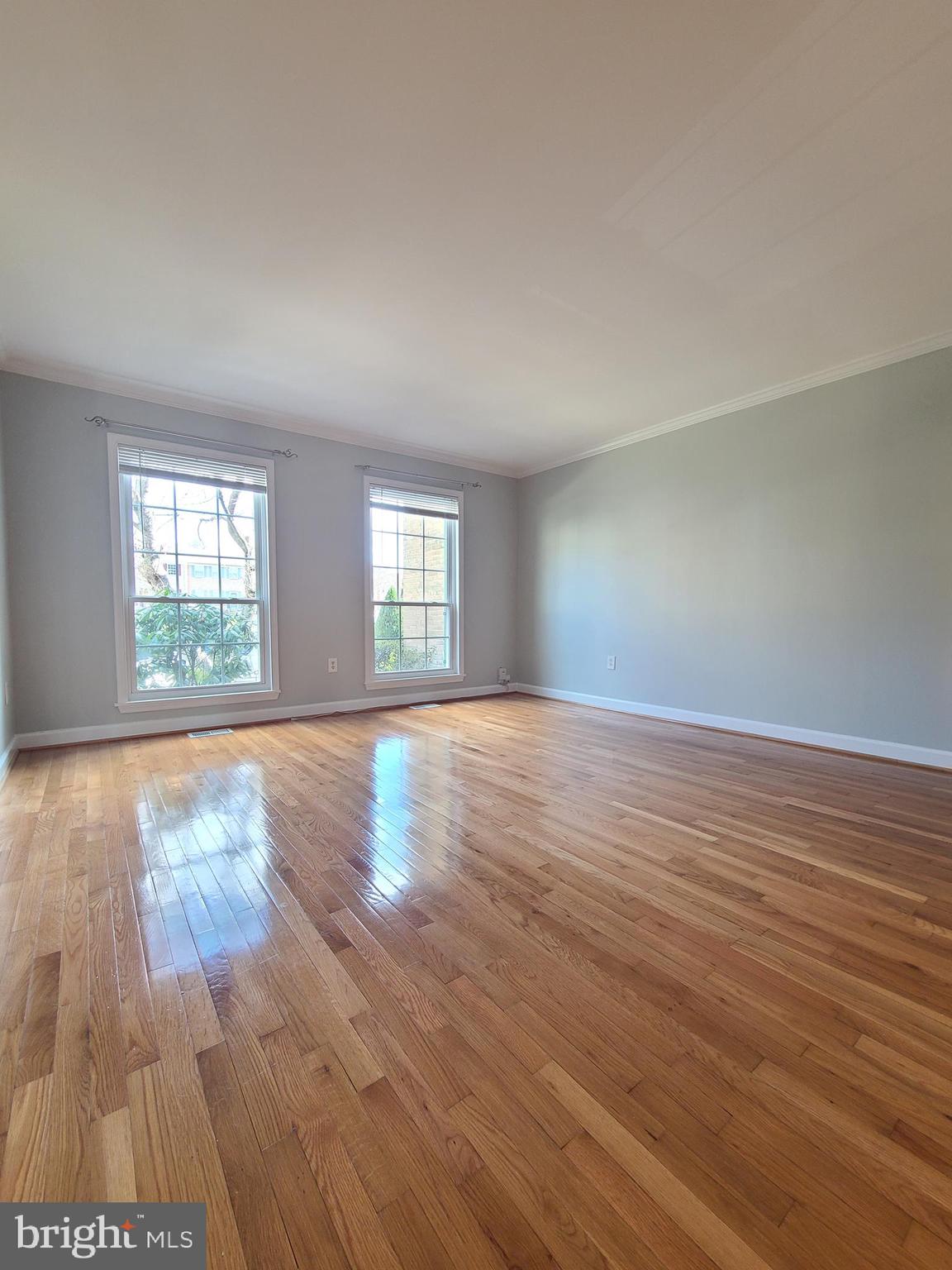 6644 Green Ash Drive Springfield, VA 22152 - Photo 7 of 42 an empty room with wooden floor and windows