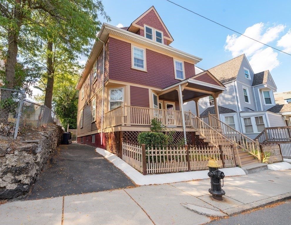 a front view of a house with iron fence