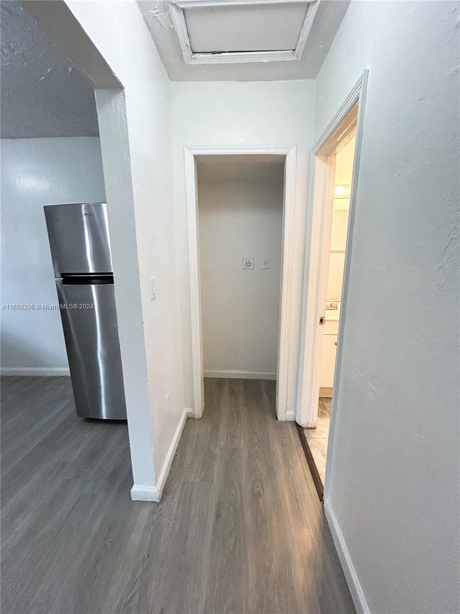 651 Northeast 86th Street, Unit 3 Miami, FL 33138 - Photo 3 of 11 a view of a hallway with wooden floor and closet