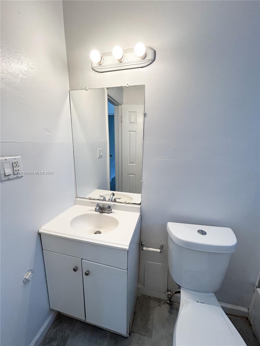 651 Northeast 86th Street, Unit 3 Miami, FL 33138 - Photo 7 of 11 a bathroom with a sink and a mirror