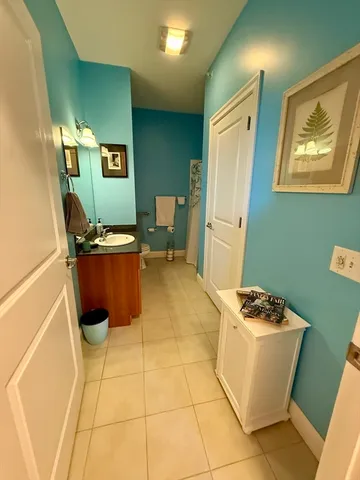 a room with furniture a air conditioner vent and a window