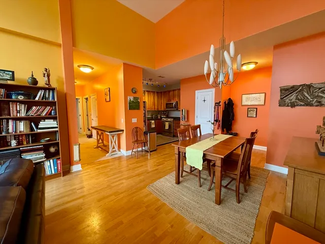a dining room with furniture and wooden floor
