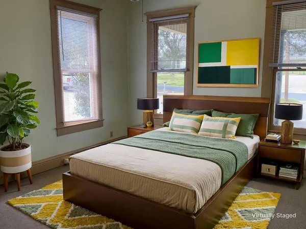 a bedroom with a bed and a potted plant