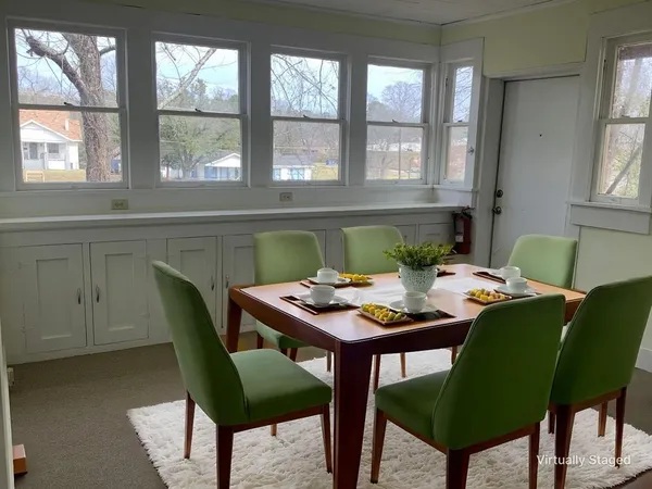 a view of a dining room with furniture and window