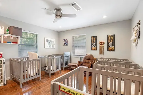 a bedroom with furniture and wooden floor
