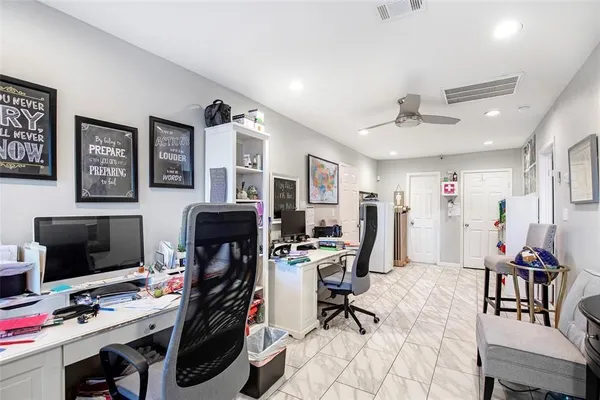 a view of a workspace with furniture and gym equipment