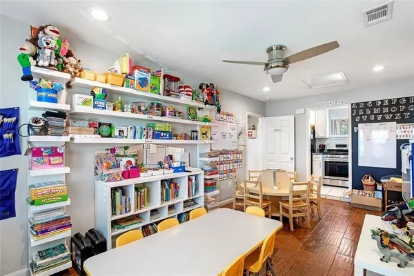 a room with furniture toys and a book shelf
