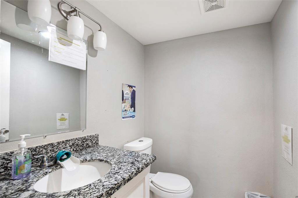 5302 Treaschwig Road Spring, TX 77373 - Photo 34 of 41 a bathroom with a granite countertop sink and a mirror