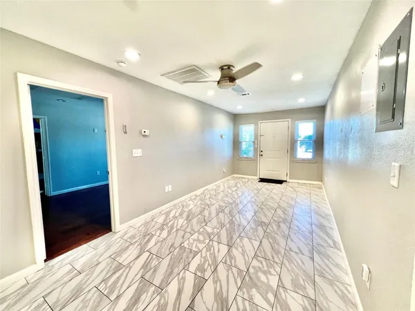 a large bedroom with a bed and a chandelier