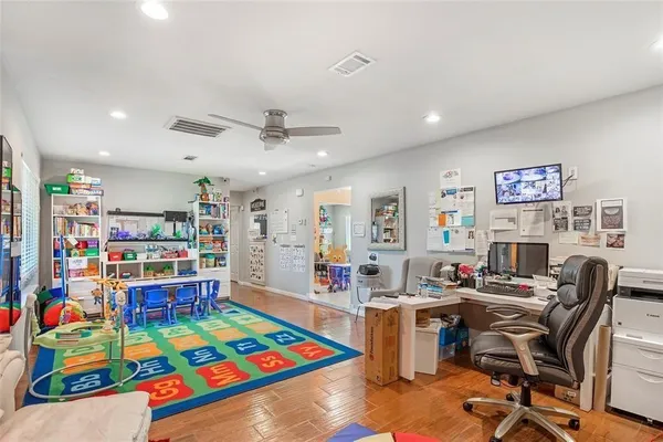a work room with furniture and a bookshelf