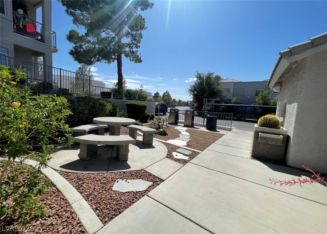 2201 Ramsgate Drive, Unit 915 Henderson, NV 89074 - Photo 13 of 36 A well-maintained community area offers a stone picnic table, surrounded by desert landscaping.