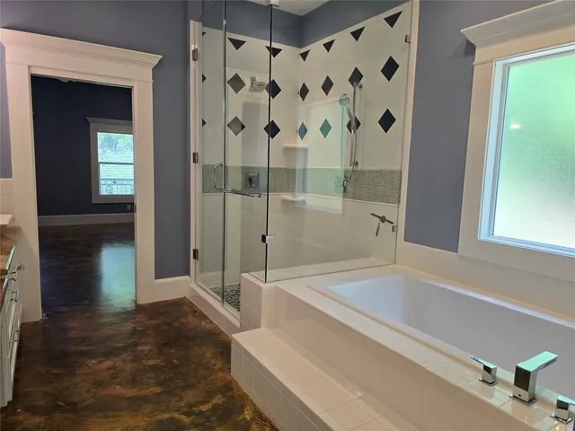 a bathroom with a bathtub and a shower