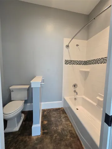 a bathroom with a toilet and a bathtub