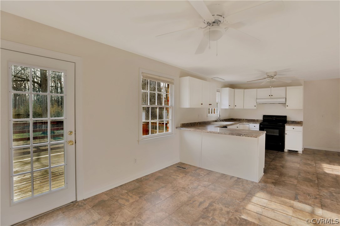 4601 Treely Road Chester, VA 23831 - Photo 15 of 27 a room with kitchen island a sink a stove a refrigerator cabinets and a window