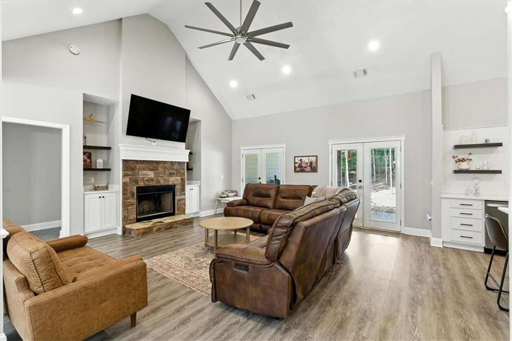 62 Joe Rowell Road Buchanan, GA 30113 - Photo 10 of 63 a living room with furniture a fireplace and a flat screen tv