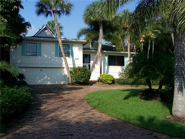 179 South River Road Sewall's Point, FL 34996 - Photo 1 of 2 a front view of a house with a garden
