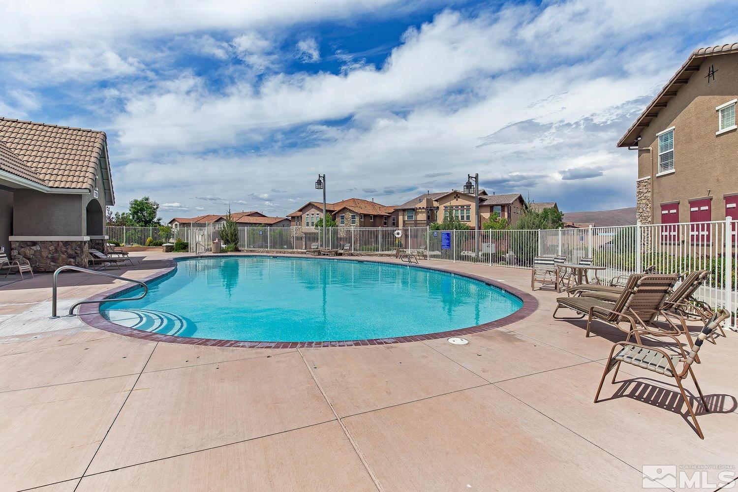 1925 Wind Ranch Road, Unit A Reno, NV 89521 - Photo 19 of 21 a view of a swimming pool with a lounge chair