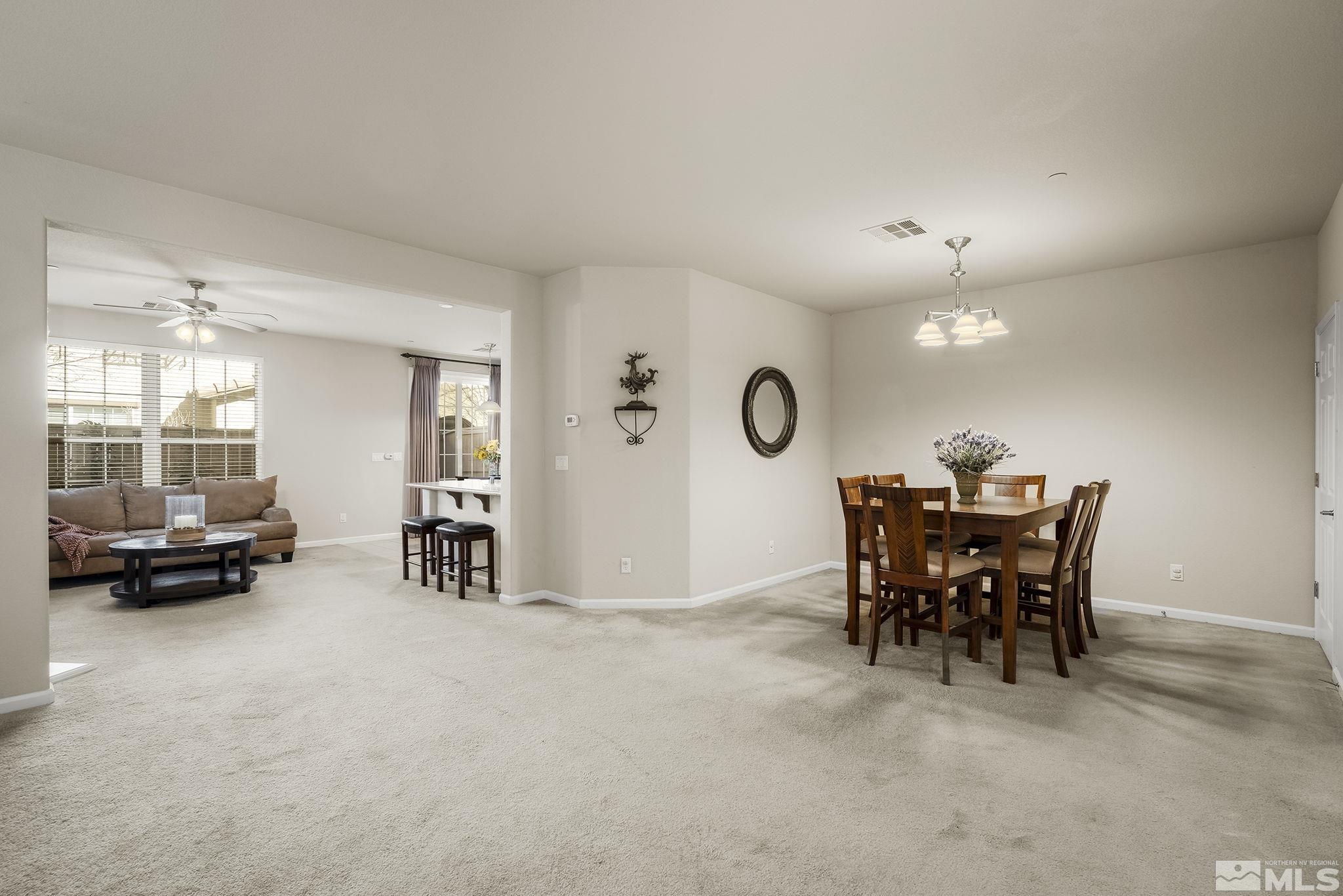 1925 Wind Ranch Road, Unit A Reno, NV 89521 - Photo 3 of 21 a view of a dining room with furniture and a chandelier
