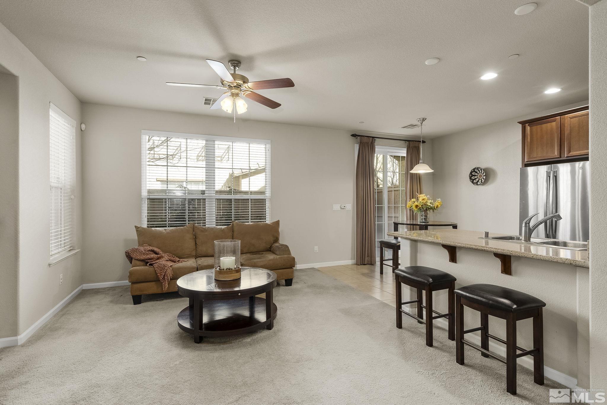 1925 Wind Ranch Road, Unit A Reno, NV 89521 - Photo 6 of 21 a living room with furniture and a large window