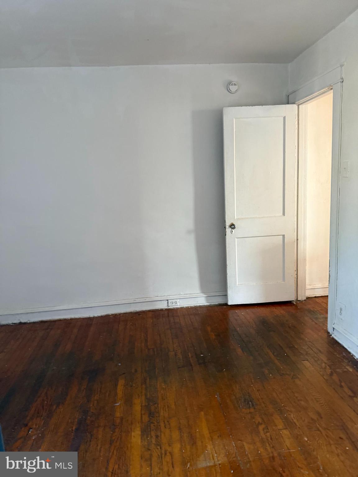 411 Timberlake Road Upper Darby, PA 19082 - Photo 8 of 15 a view of an empty room with wooden floor and a window