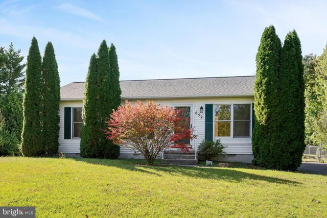 a front view of a house with a yard garage and outdoor seating
