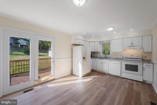 a kitchen with stainless steel appliances a refrigerator and a stove top oven
