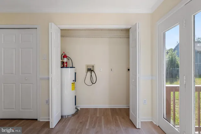 a view of a hallway with wooden floor and closet
