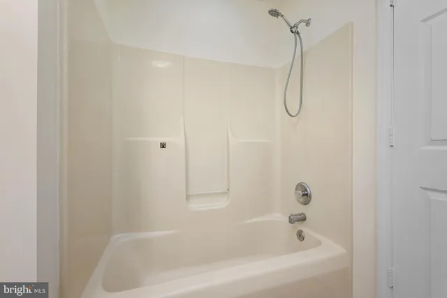 a bathroom with a bath tub with a shower