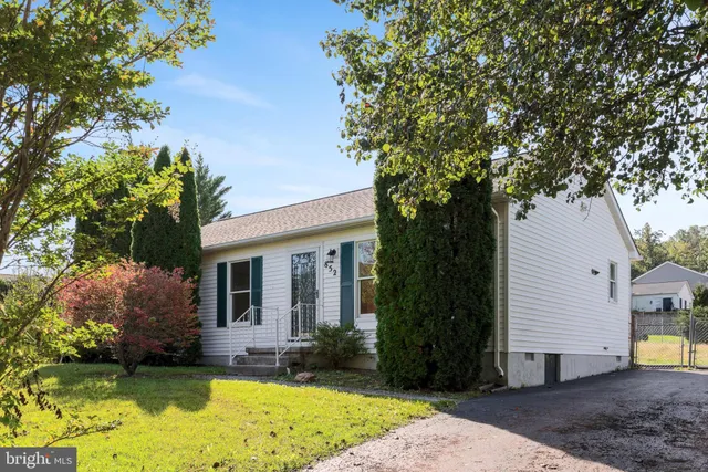 a view of a house with pool and garden