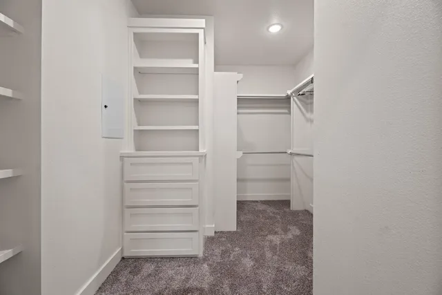 a view of walk in closet with empty racks