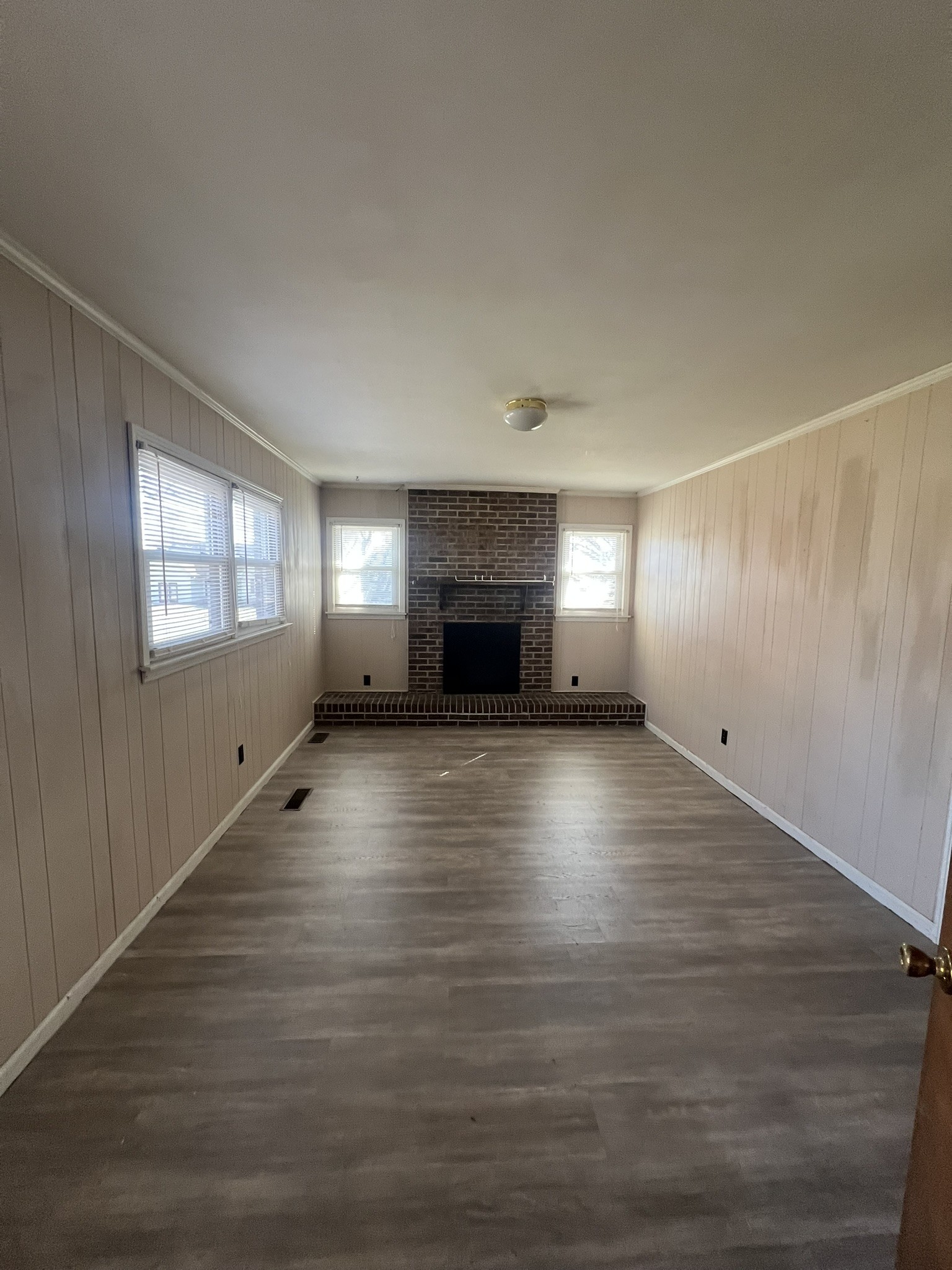 442 Rodney Street Gallatin, TN 37066 - Photo 4 of 21 an empty room with windows and fireplace