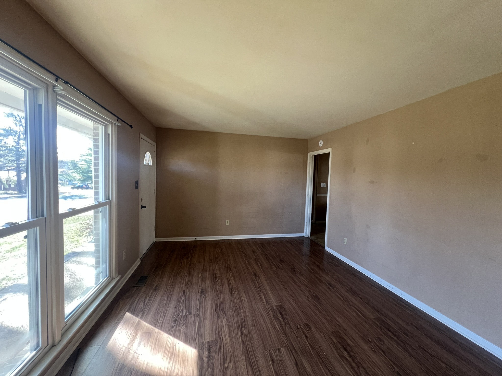 442 Rodney Street Gallatin, TN 37066 - Photo 6 of 21 a view of an empty room with wooden floor and a window