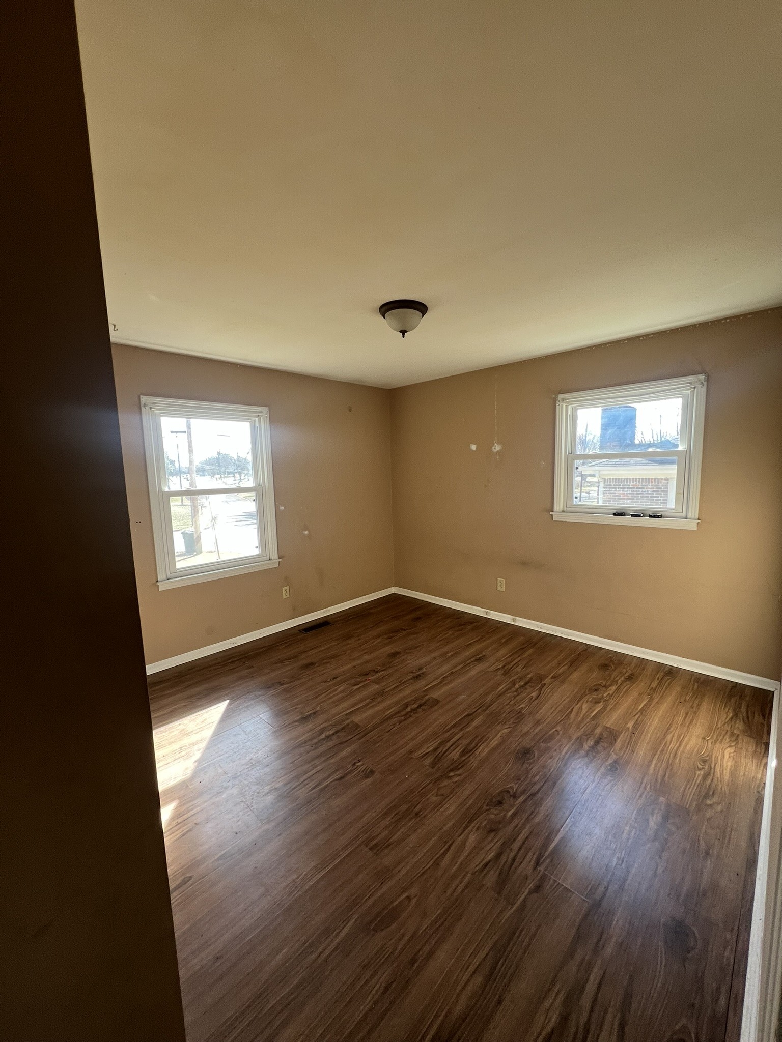 442 Rodney Street Gallatin, TN 37066 - Photo 8 of 21 a view of an empty room with wooden floor and a window