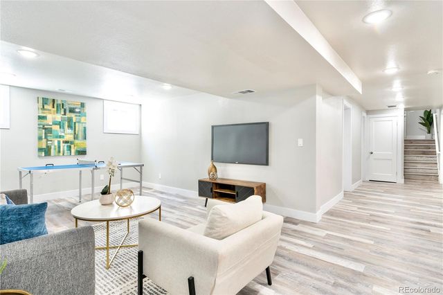 a view of a dining room with furniture and wooden floor