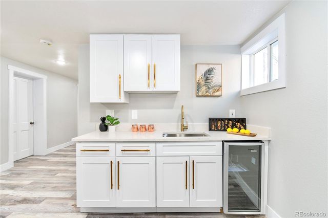 a white bed sitting in a bedroom next to a window