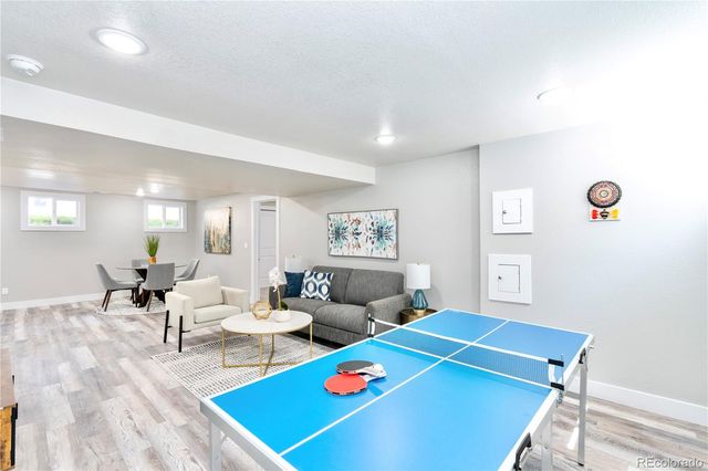 a kitchen with a dining table chairs and white cabinets