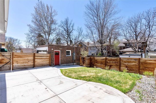 a porch with a bench next to a large window