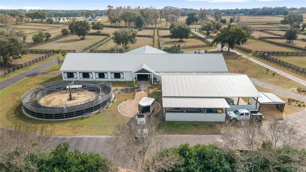an aerial view of a house with swimming pool and mountain view
