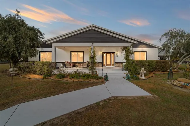 a view of a house with a yard and a water fountain