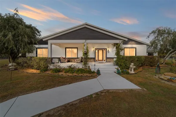 a view of a house with a yard and a water fountain