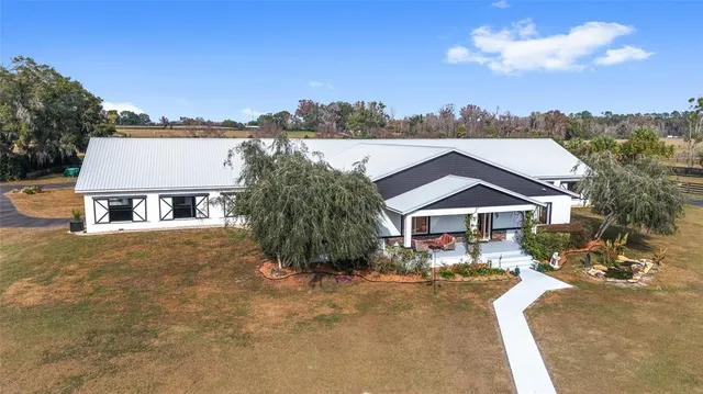 an aerial view of residential house with outdoor space and lake view