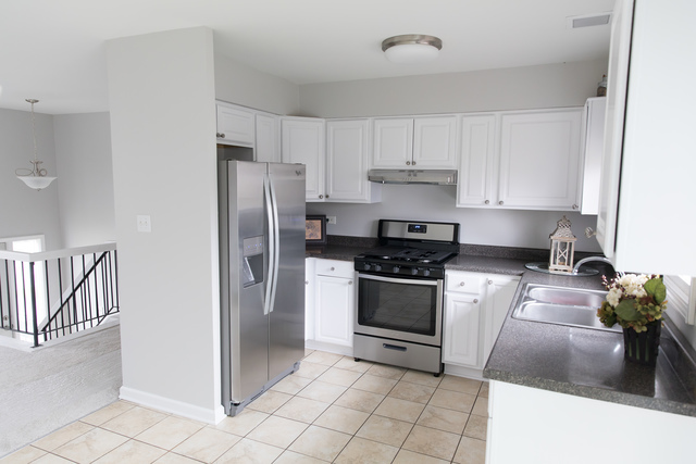 225 Huntingwood Road Matteson, IL 60443 - Photo 2 of 14 a kitchen with granite countertop a stove sink and refrigerator
