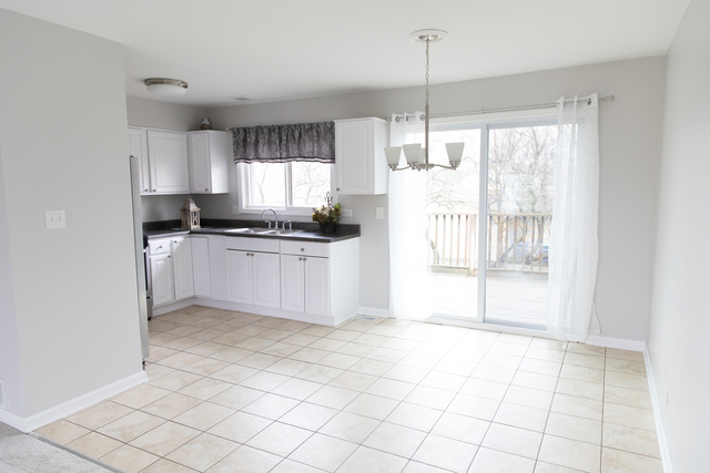 225 Huntingwood Road Matteson, IL 60443 - Photo 3 of 14 a kitchen with granite countertop a stove a sink and cabinetry