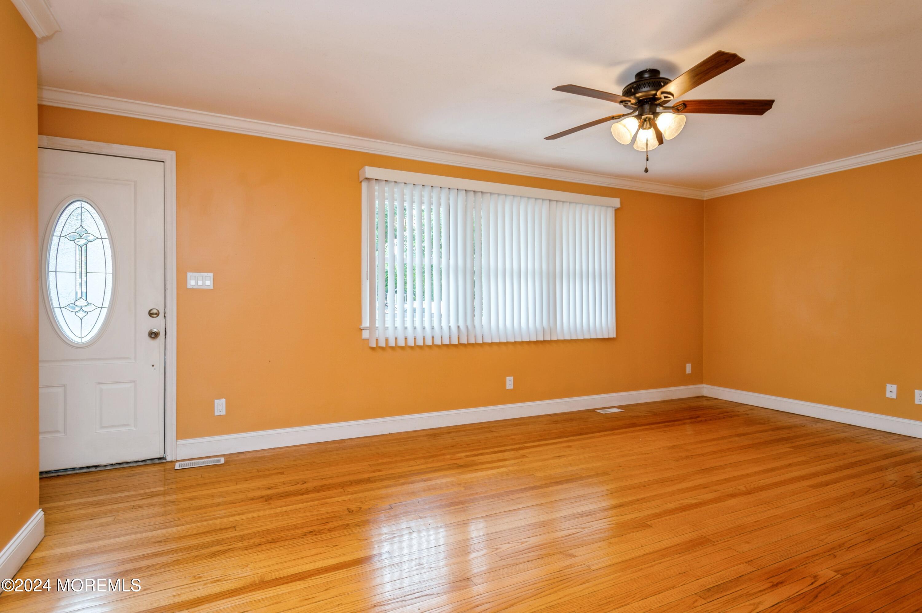 19 Holly Road Brick, NJ 08723 - Photo 2 of 16 a view of empty room with wooden floor and fan