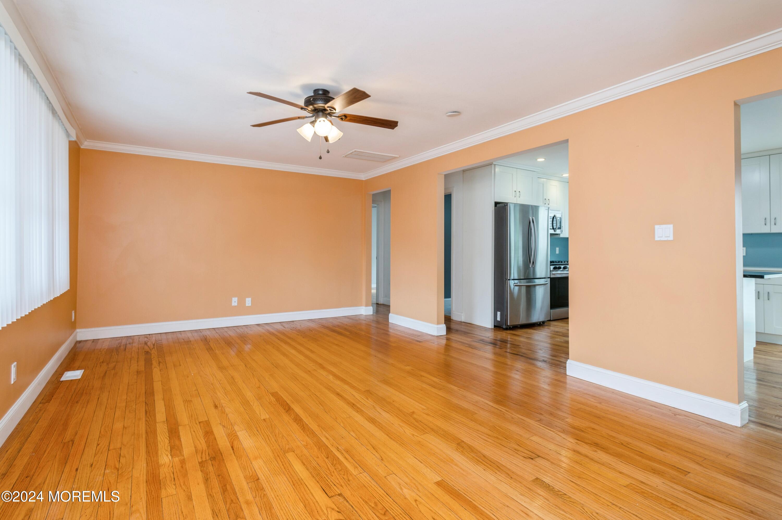 19 Holly Road Brick, NJ 08723 - Photo 3 of 16 a view of an empty room with wooden floor and a window
